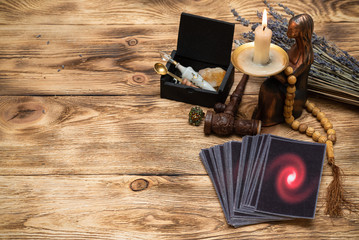 Tarot cards on the old wooden table background.