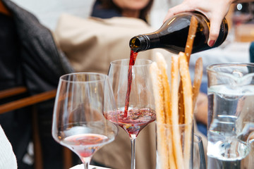 Pouring red wine in a glass in restaurant