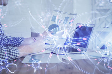 Neuron hologram with man working on computer on background. Education concept. Double exposure.