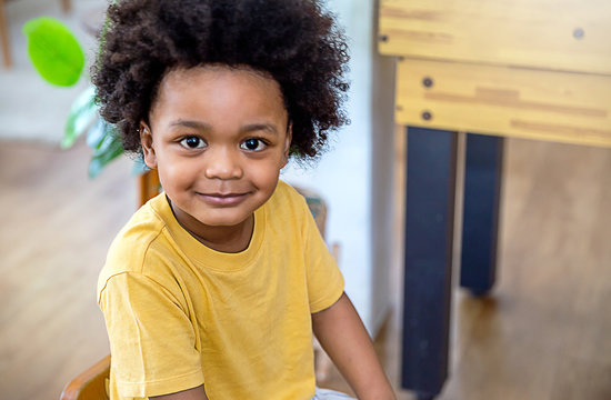 Fun In The Spring Park. Portrait Of Young Happy Little Afro Black Boy Stand On Green Grass Background. Education Back To School Spend Leisure Time In Nature Forest, Authentic Concept