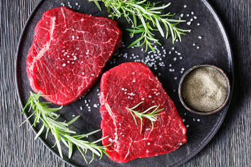 dry-aged beef steaks on a black plate