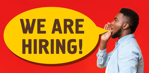 Side view of black man screaming WE ARE HIRING on red background, collage