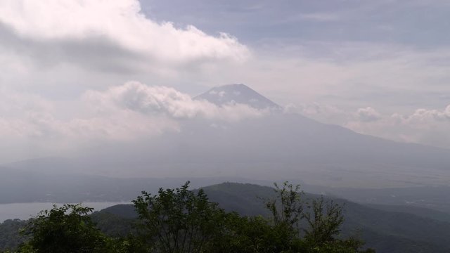 Timelapse of rolling clouds looking out towards Mount Fuji and Lake Yamanaka on a bright and sunny day