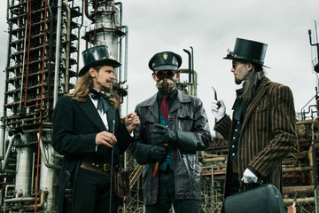 Three mans in steampunk style