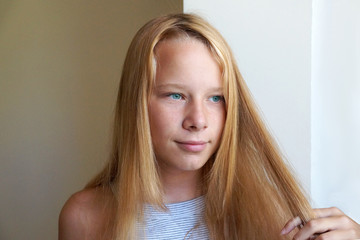 portrait of smiling girl with long blond hair