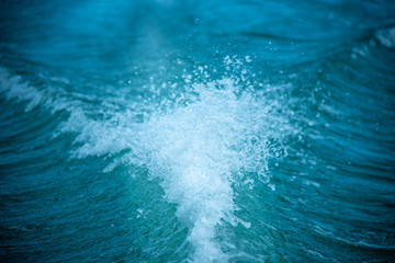 Background of water splash wave surface behind of fast moving motor speed boat