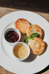 Breakfast in cafe with cheesecakes with jam.