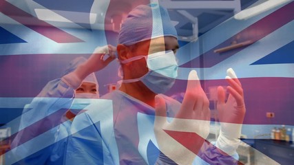 Animation of UK flag with healthcare worker in background during coronavirus pandemic - Powered by Adobe