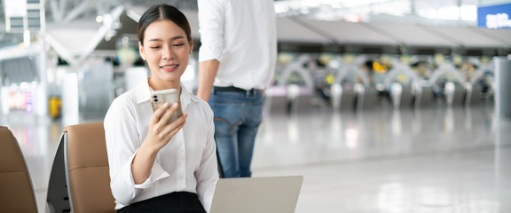 New normal and social distancing concept.businesswoman using smartphone or laptop computer...
