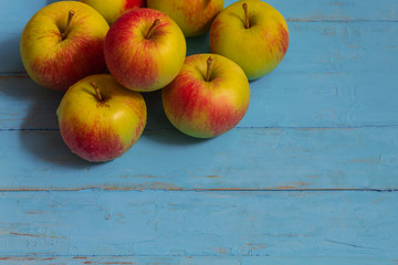 Apples on a blue wooden background in the number of eight pieces
