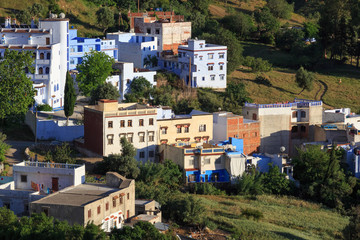 Obraz premium View of the residential buildings in suburb of Chefchaouen, Morocco. The city, also known as Chaouen is noted for its buildings in shades of blue and that makes Chefchaouen very attractive to visitors
