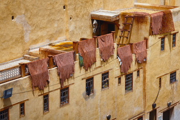 The leathers are dried on the roofs of the old tannery buildings in Fez. Morocco. The tanning...