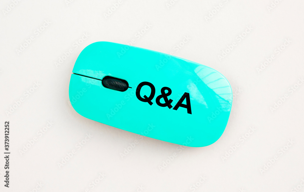 Poster q and a word acronym on computer mouse on white table