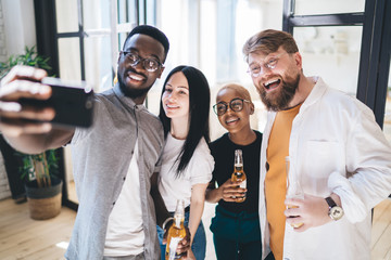 Diverse joyful company taking selfie