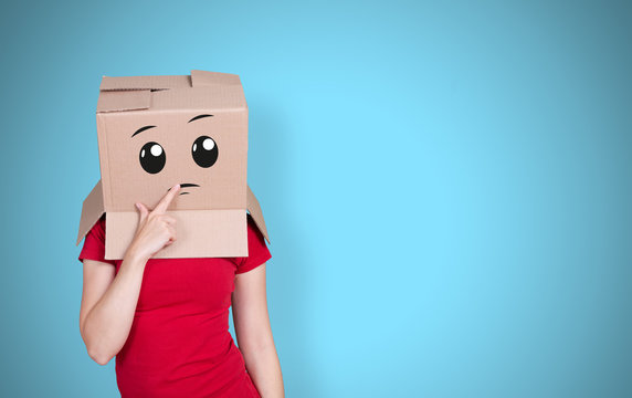 Person With Cardboard Box On Its Head And A Thoughtful Face Expression On Light Blue Background