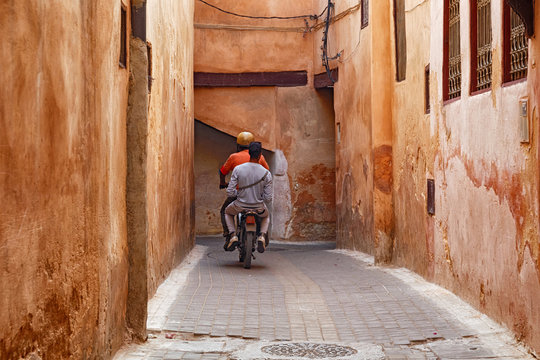 Unknown men on the scooter in Meknes medina. Meknes is one of the four Imperial cities of Morocco and the sixth largest city by population in the kingdom.