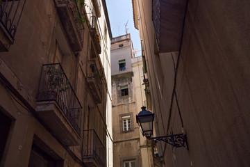 View of the historical narrow street with old residential buildings in center of Barcelona. Spain.