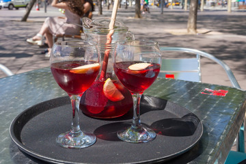 Jug and glasses with sangria beverage on the table in street cafe in center of Barcelona. Spain.