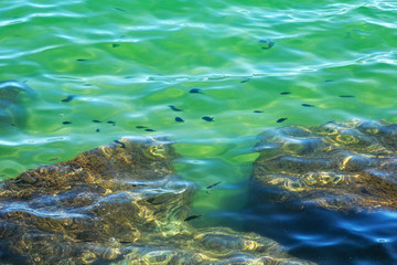 View of the stones in the Mediterranean sea in sunny day.