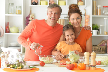 Portrait of family cooking together at kitchen table