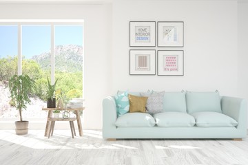 White living room with sofa and summer landscape in window. Scandinavian interior design. 3D illustration