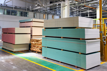 Gypsum plasterboard in pack. Pallet with plasterboard in the building store. Construction Materials. Drywall warehouse