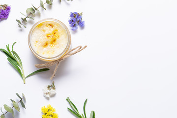 Organic homemade body scrub made with essential oils and herbs in white background with copy space for your text. Natural cosmetic concept. Home spa concept.