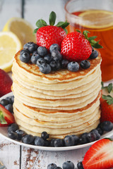 A stack if home-made pancakes with berry