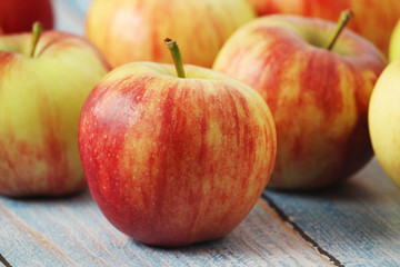 Several ripe red apples on the wooden table