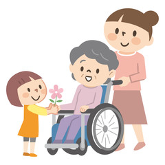 車椅子のシニア女性と家族