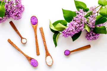 Sea salt spa set with pink lilac flowers. Top view