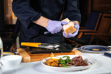 Restaurant chef scraping shavings of parmesan