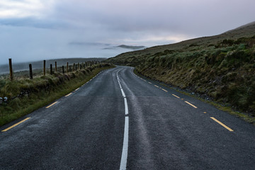 Empty roadway through the Dingle peninsula during misty