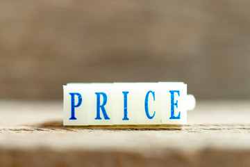 Letter block with blue color word price on wood background