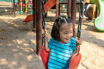 Asian children with toy in playground. Little girl happy to play outside at park.