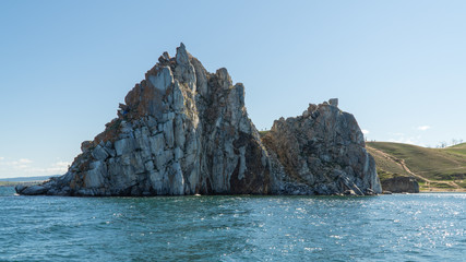 Shamanka Rock on Olkhon. Cape Burhan. rock near the shore, view from the water.