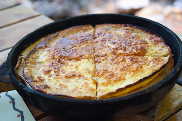 Traditional Kosovo pie - layered pita rednica stuffed with cheese and baked in a special pot, sac
