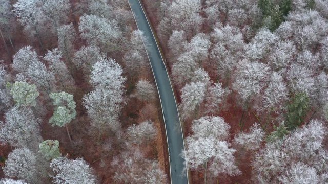 Aerial view of road with blue car in winter, Steigerwald, Germany