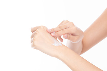 Closeup beautiful young woman hands applying moisturizing hand cream on skin isolated on white background.