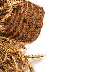 Delicious bread. Fresh loaf of rustic traditional bread with wheat grain ear or spike plant isolated on white background. Rye bakery with crusty loaves and crumbs. Homemade baking.