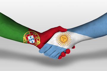 Handshake between argentina and portugal flags painted on hands, illustration with clipping path.