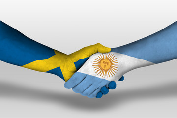 Handshake between argentina and sweden flags painted on hands, illustration with clipping path.
