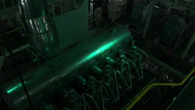 A real and top view of a huge ships main engine.