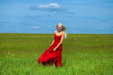 portrait of a young beautiful blonde woman in red dress