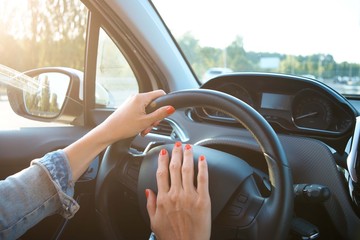 Women's hands on the wheel. Cars interior