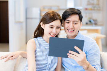 couple use tablet at home