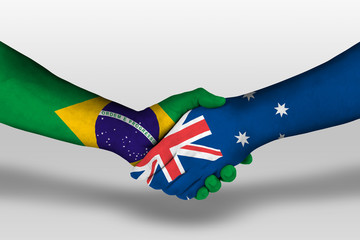 Handshake between Australia and brazil flags painted on hands, illustration with clipping path.
