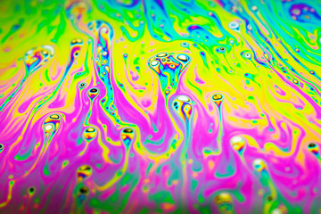 Beautiful psychedelic abstraction formed by light on the surface of a soap bubble