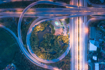 Aerial view of higway road and movement vehicle in Chiang Mai city of Thailand at twilight.