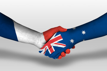 Handshake between Australia and france flags painted on hands, illustration with clipping path.